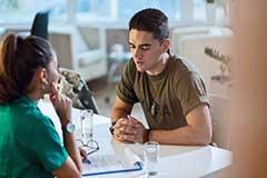 Male talking to female at desk